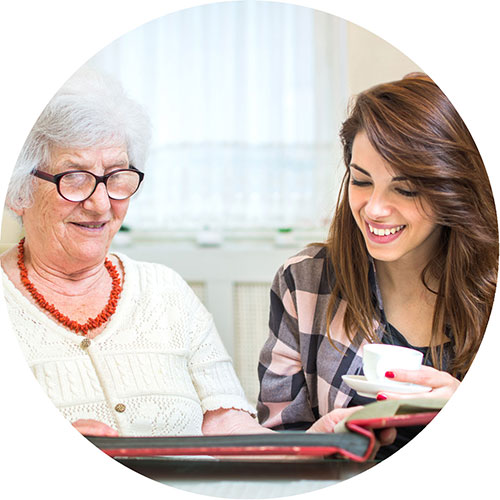 Caregiver helping senior with medical alert device